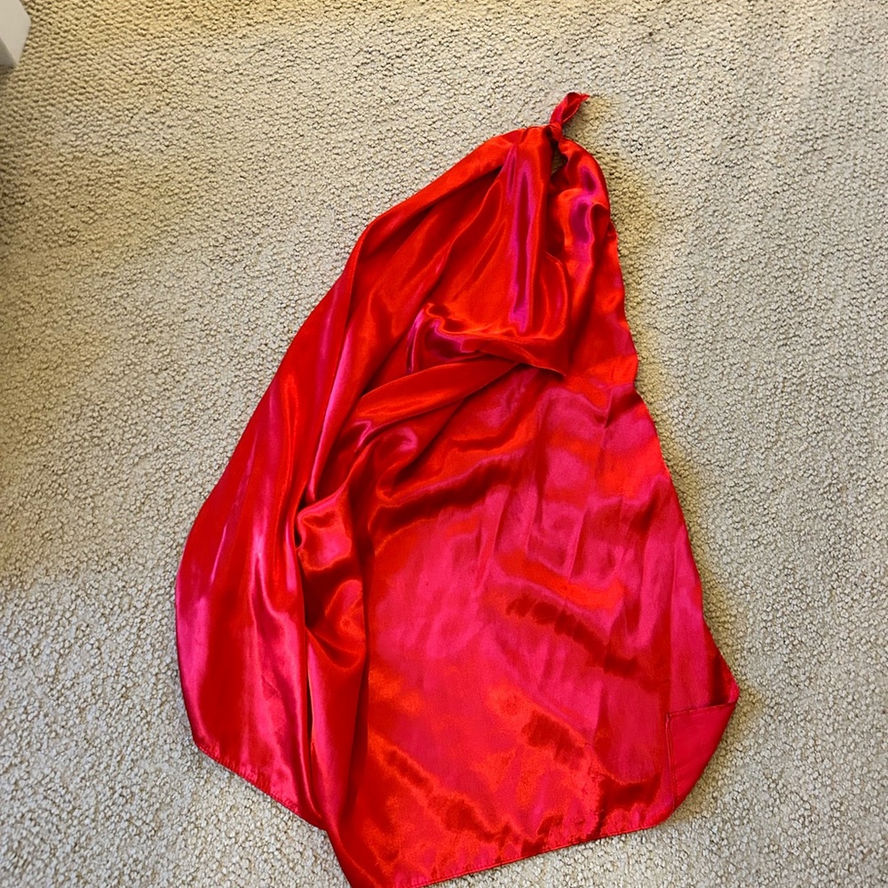 red scarf top that can be tied different ways (shown by the other scarf top)